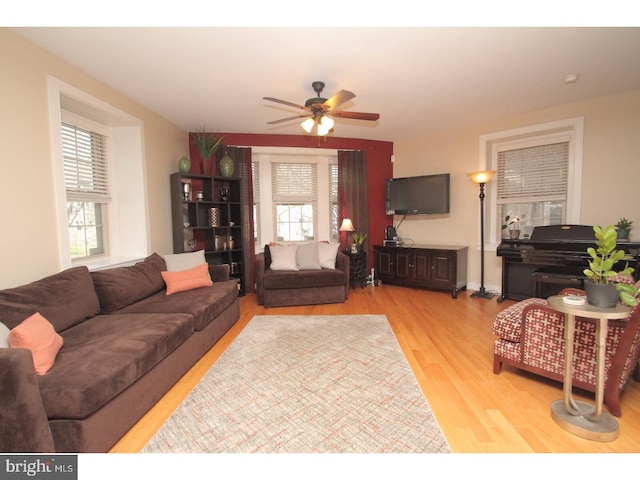 living room featuring light hardwood / wood-style flooring and ceiling fan