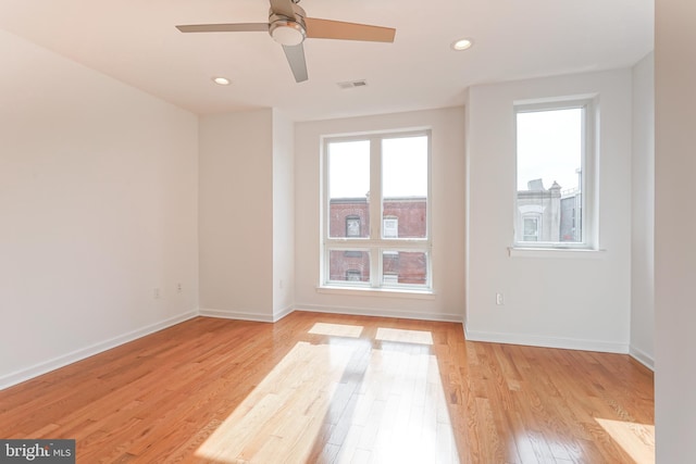 empty room featuring ceiling fan and light hardwood / wood-style floors