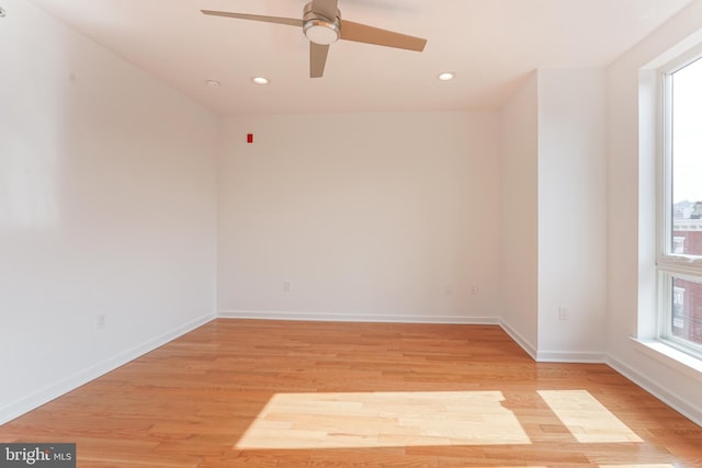 spare room featuring light hardwood / wood-style floors and ceiling fan