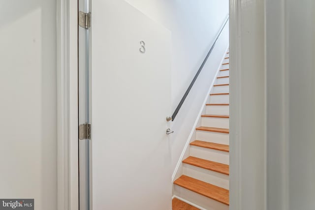 stairs featuring hardwood / wood-style flooring