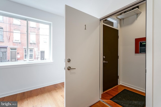 doorway to outside with wood-type flooring