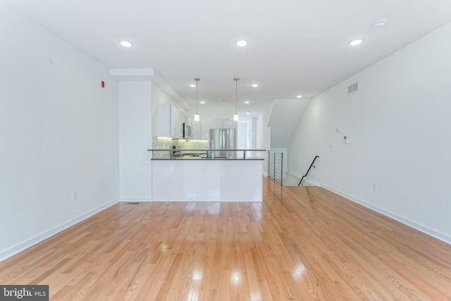 unfurnished living room with light hardwood / wood-style flooring