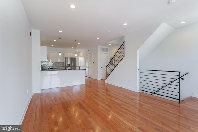 unfurnished living room with light hardwood / wood-style floors