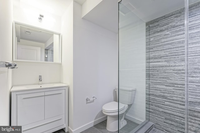 bathroom featuring vanity, tile patterned floors, and toilet