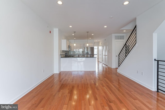 unfurnished living room with light hardwood / wood-style floors