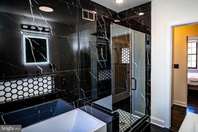 bathroom with plus walk in shower and wood-type flooring