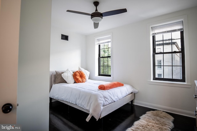 bedroom with dark wood-type flooring and ceiling fan