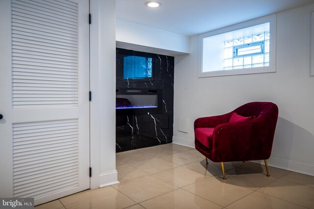 bathroom featuring enclosed tub / shower combo, tile patterned floors, and vanity