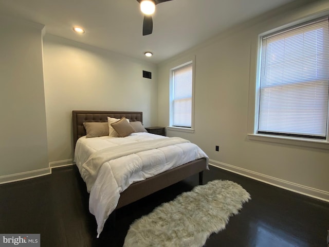 bedroom with ceiling fan and dark wood-type flooring