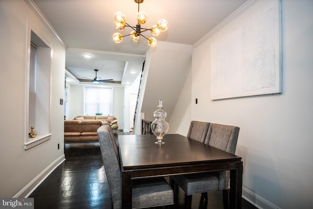 dining area featuring ornamental molding, dark hardwood / wood-style flooring, and ceiling fan with notable chandelier