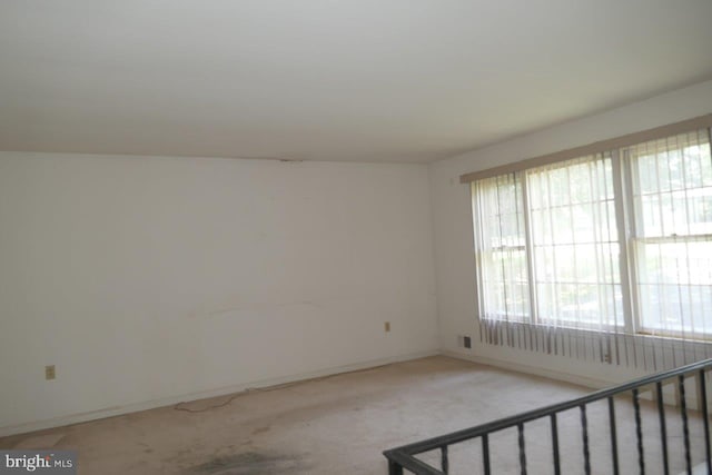 unfurnished room with carpet flooring