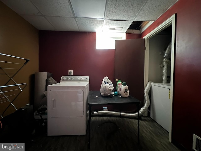 laundry room with independent washer and dryer and dark hardwood / wood-style floors