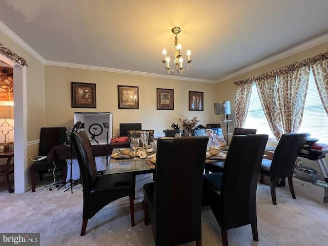 dining space featuring an inviting chandelier, crown molding, and carpet