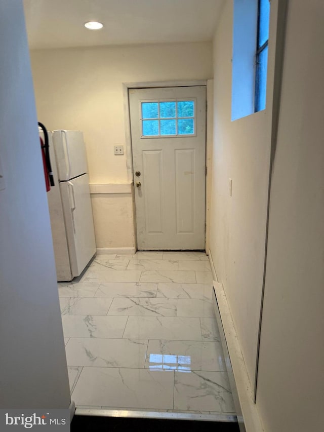 doorway with light tile patterned floors