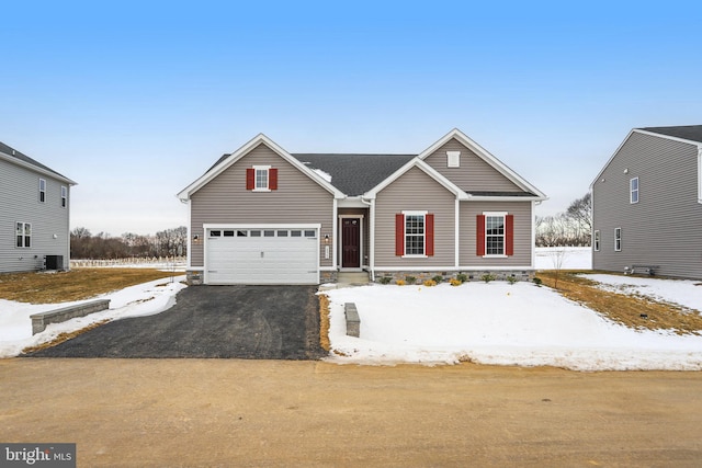 view of front facade with a garage and central AC