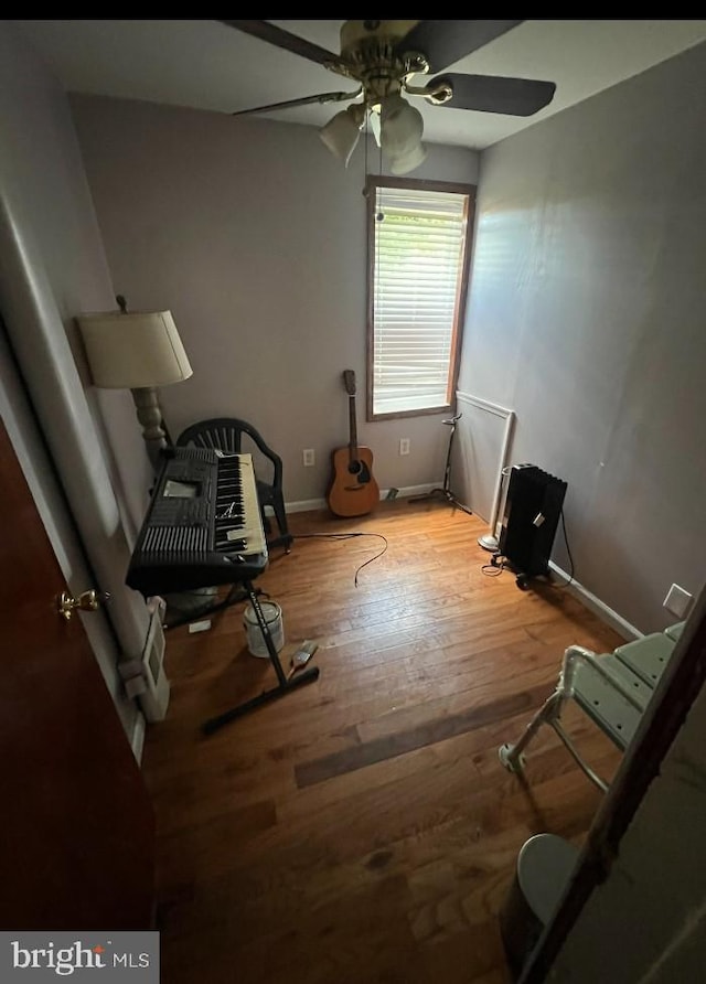 living area with ceiling fan and light hardwood / wood-style floors