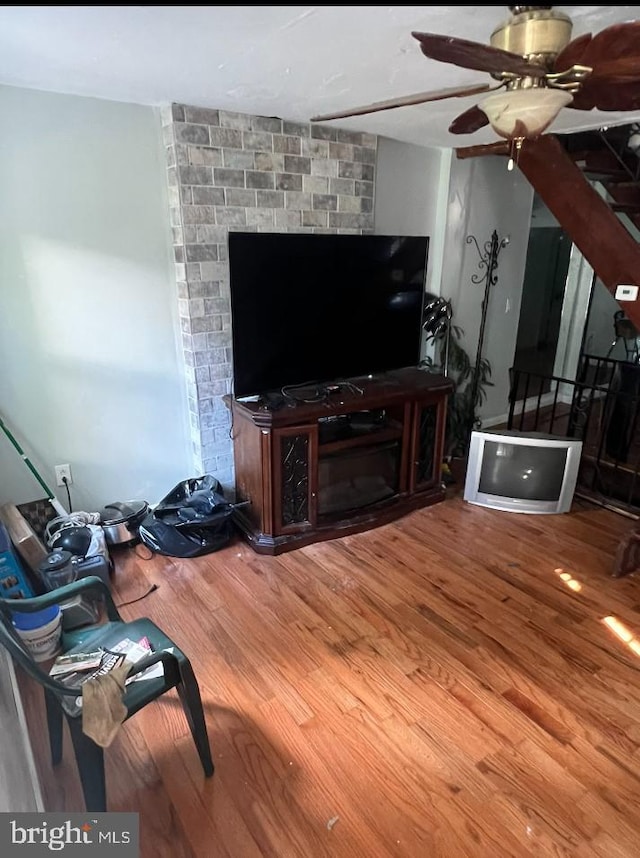 living room with ceiling fan and hardwood / wood-style floors