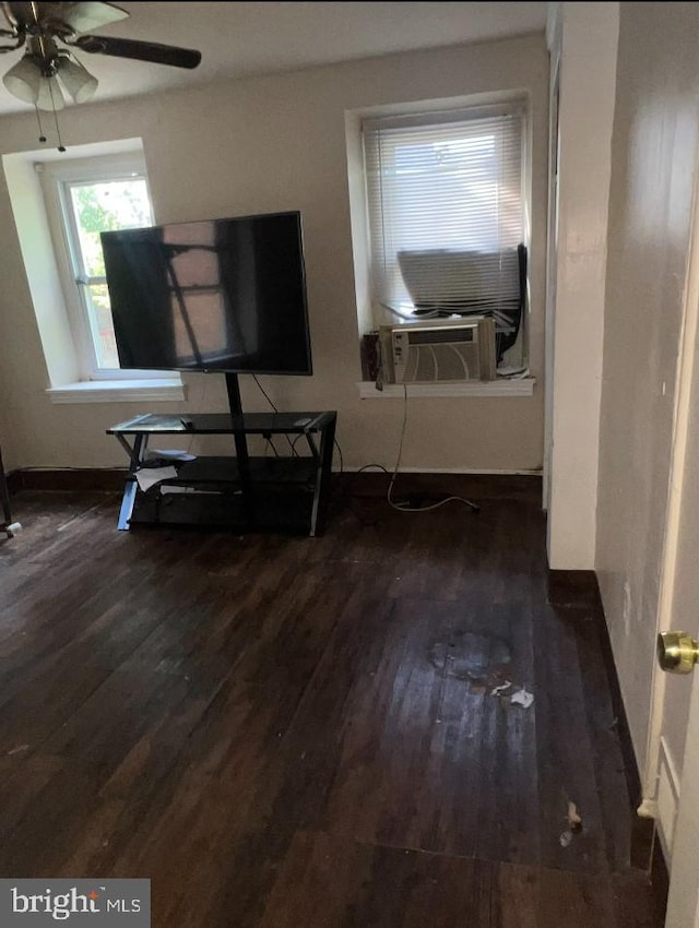 interior space featuring dark hardwood / wood-style floors, ceiling fan, and cooling unit