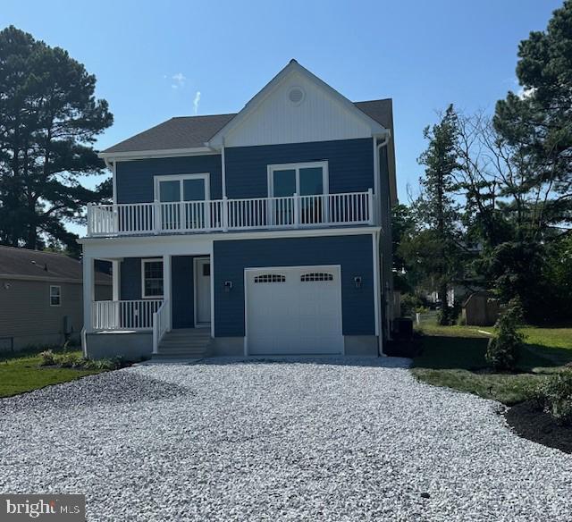 view of front property with a balcony and a garage