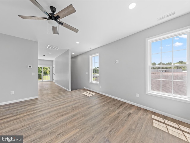 unfurnished living room with ceiling fan and hardwood / wood-style floors