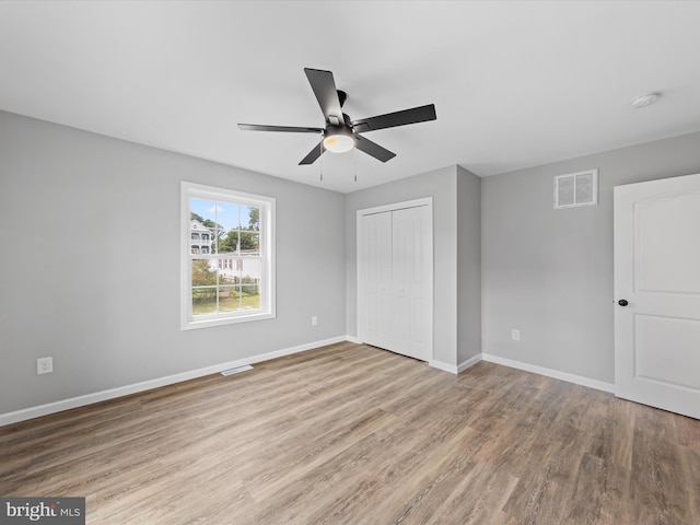 interior space with wood-type flooring and ceiling fan