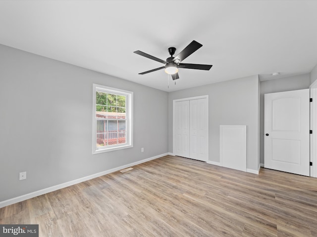 unfurnished bedroom with a closet, light wood-type flooring, and ceiling fan