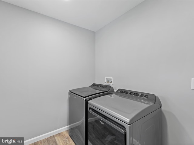 laundry area featuring washer and dryer and light wood-type flooring