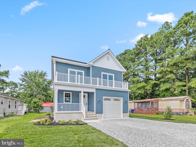 view of front facade featuring a garage, a porch, a balcony, and a front lawn