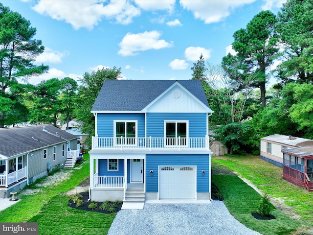 view of front facade featuring a garage, covered porch, and a front yard