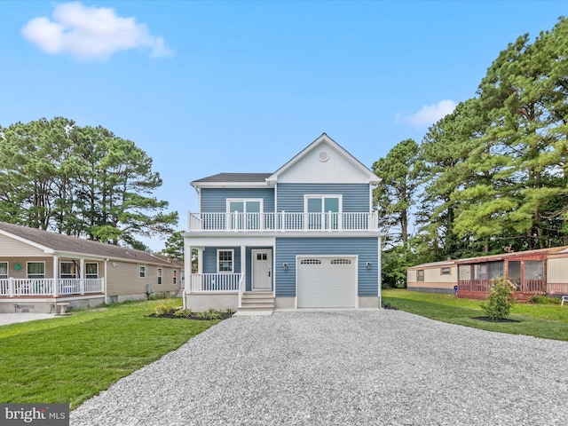 view of front of property featuring a garage, a front yard, and covered porch