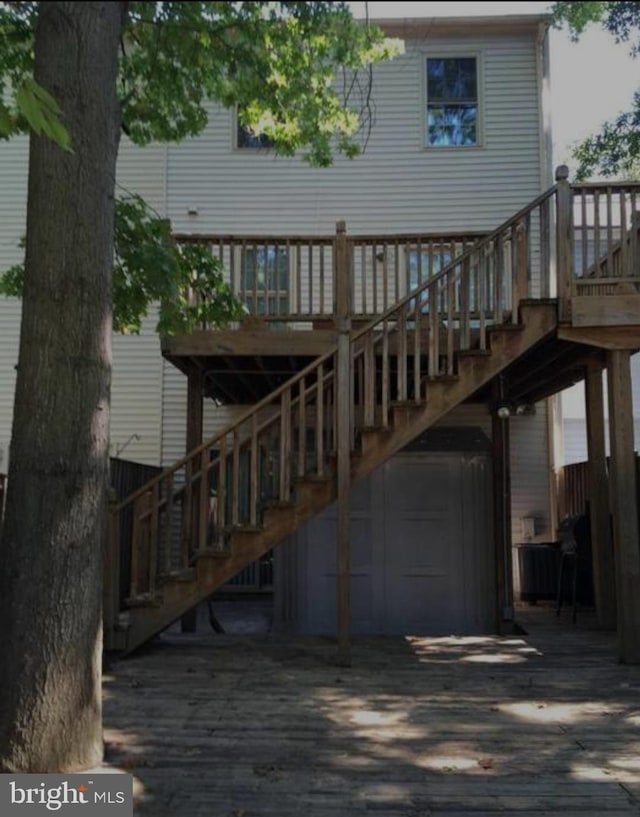 rear view of property with a wooden deck