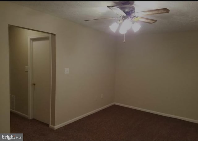 carpeted spare room featuring a textured ceiling and ceiling fan