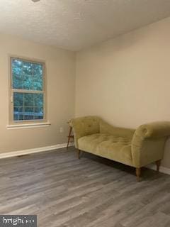 unfurnished room with dark wood-type flooring and a textured ceiling