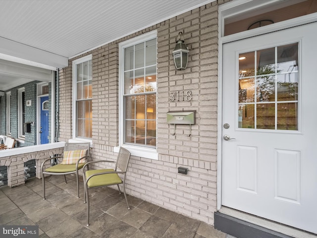 doorway to property featuring covered porch