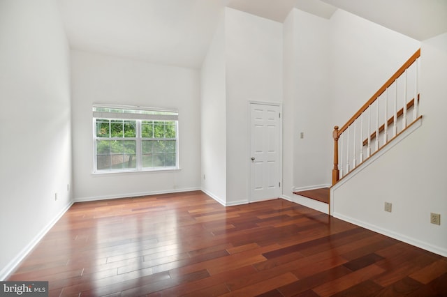 interior space with a high ceiling and wood-type flooring