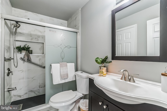 bathroom with vanity, toilet, and walk in shower