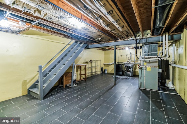 basement featuring tile patterned flooring and independent washer and dryer