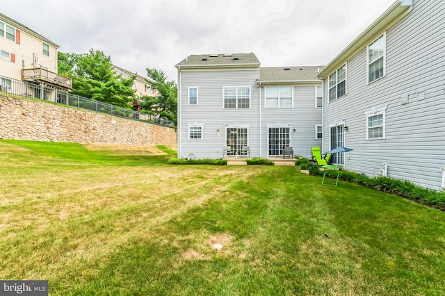 back of house with a lawn