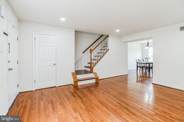 foyer with a notable chandelier and light wood-type flooring