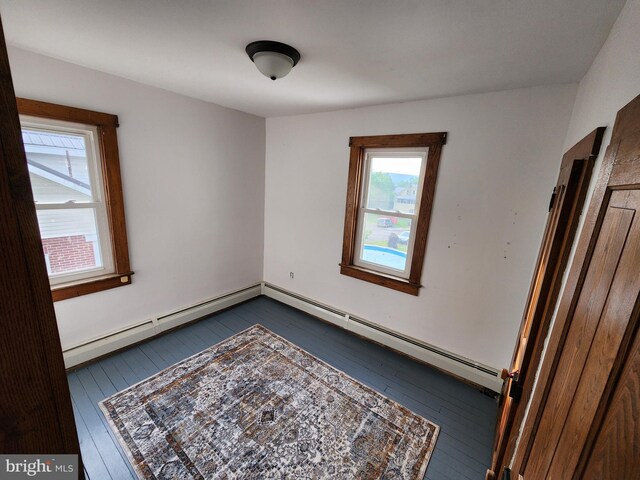 spare room with a baseboard radiator and hardwood / wood-style flooring