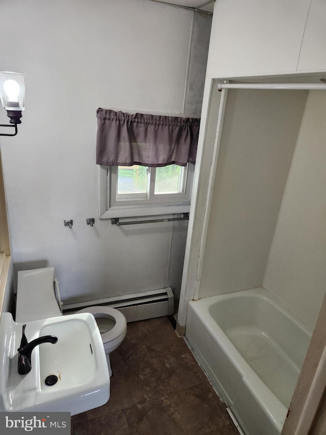 full bathroom with washtub / shower combination, tile patterned floors, toilet, and sink