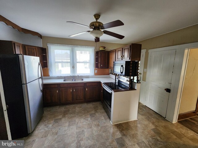 kitchen with appliances with stainless steel finishes, light tile patterned flooring, ceiling fan, and sink