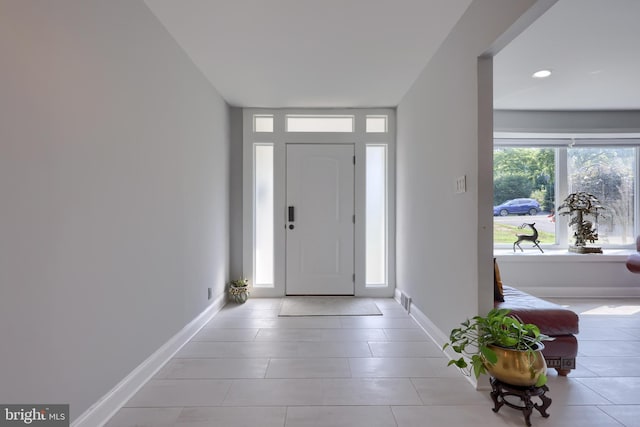 entryway featuring light tile patterned flooring and plenty of natural light