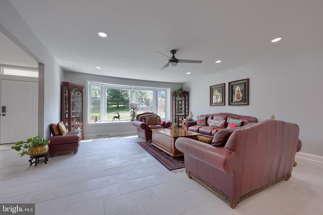 living room with light tile patterned flooring and ceiling fan