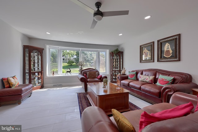 living room featuring light tile patterned flooring and ceiling fan