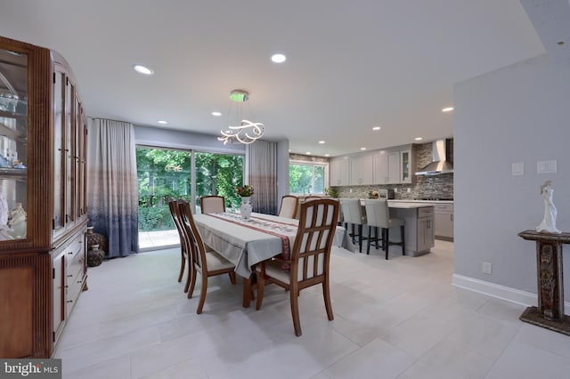 dining space with an inviting chandelier and light tile patterned floors