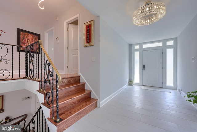 foyer with a chandelier