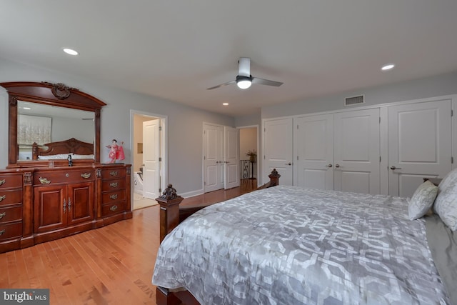 bedroom with light hardwood / wood-style floors, connected bathroom, and ceiling fan