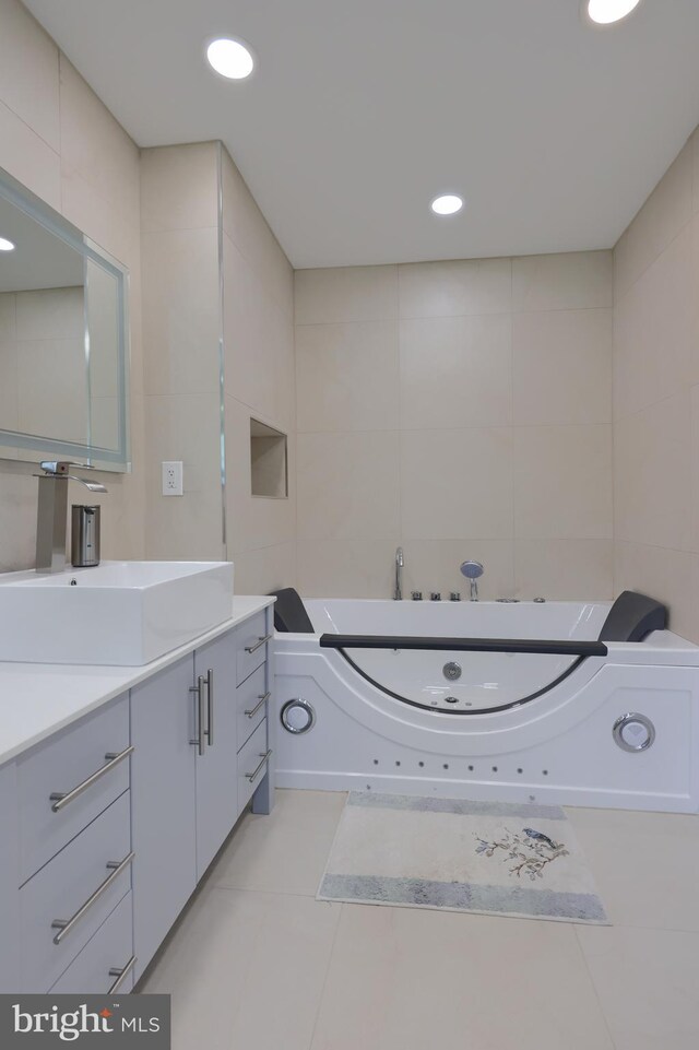 bathroom featuring tile walls, tile patterned floors, and vanity