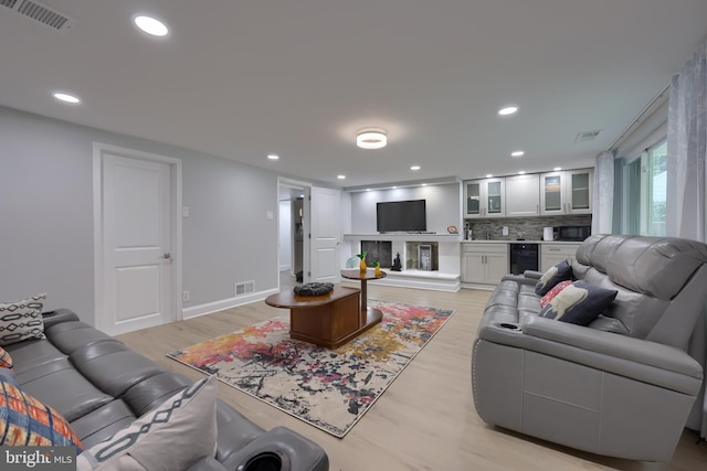 living room featuring beverage cooler and light wood-type flooring